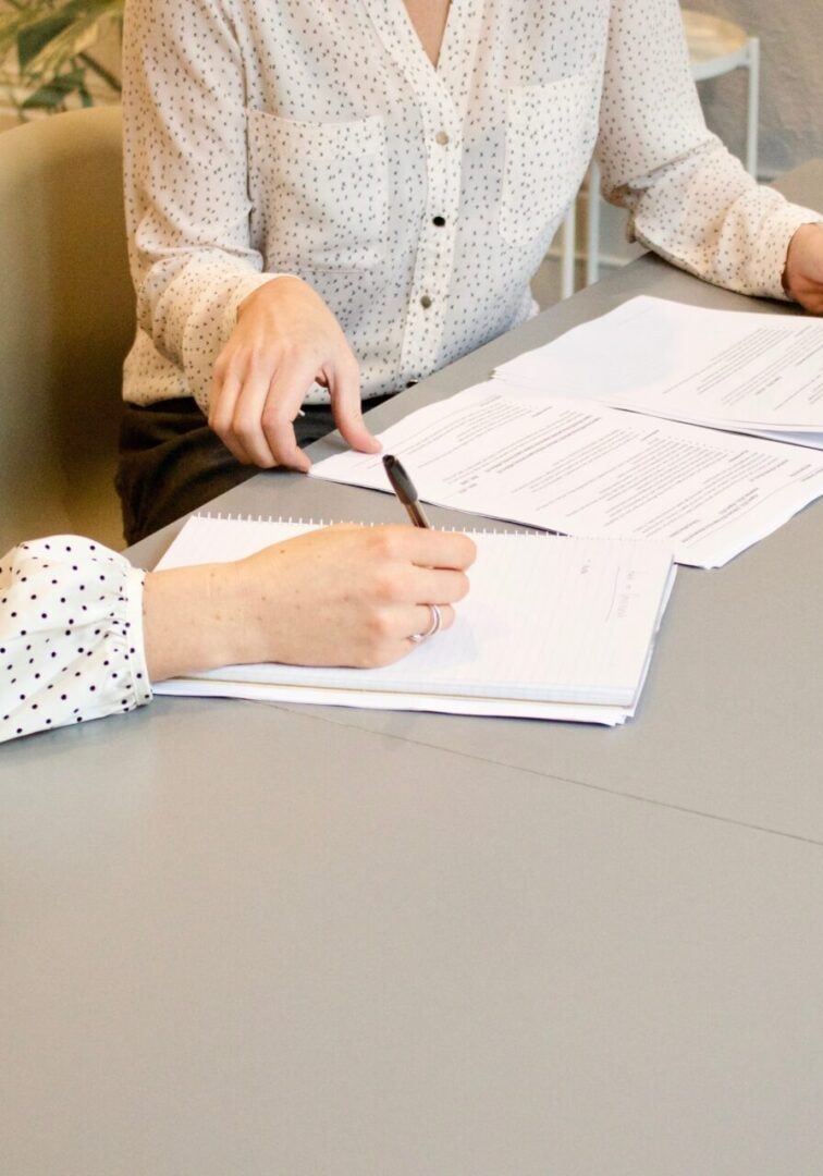Two professionals reviewing insurance documents at a desk